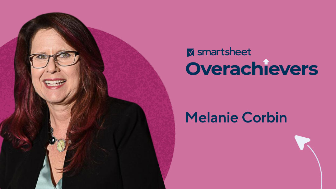 Smartsheet Overacheiver Melanie Corbin of MedPOINT Management smiles for the camera alongside Smartsheet Overachivers logo.
